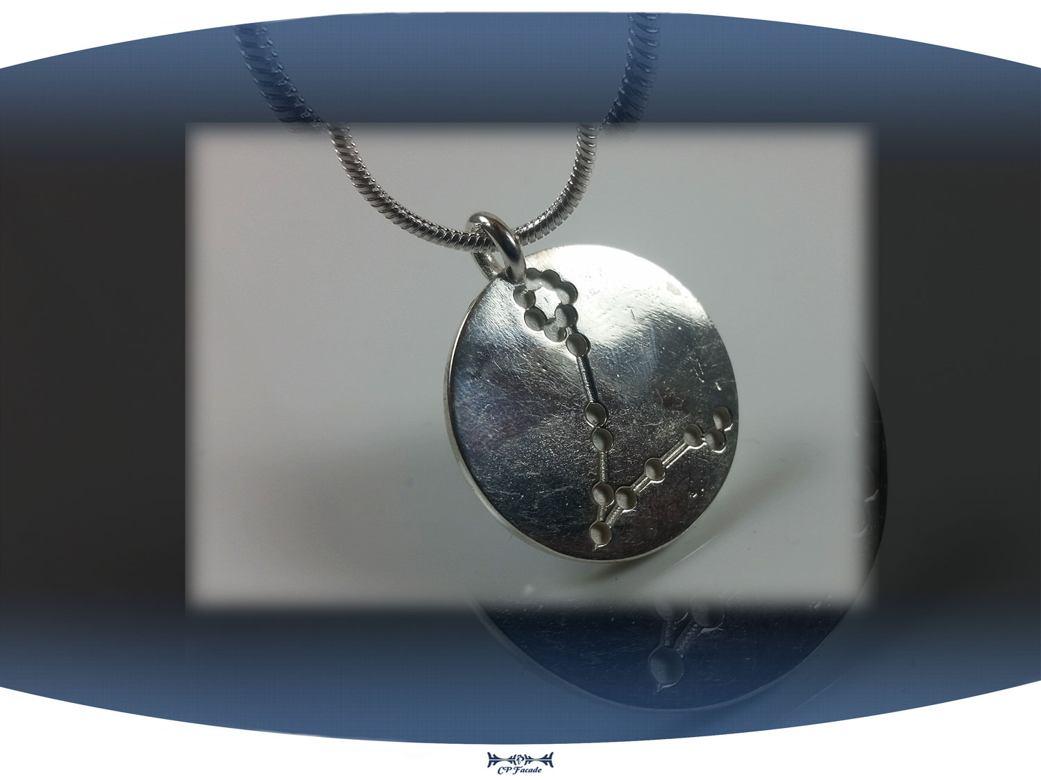 Close up of back of pisces zodiac pendant showing aquarius star constellation